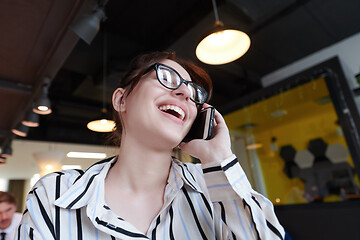 Image showing portrait of businesswoman with glasses using mobile phone