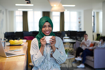 Image showing african muslim business woman drinking tea