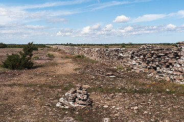 Image showing Stone cairn by a trail along a dry stone wall