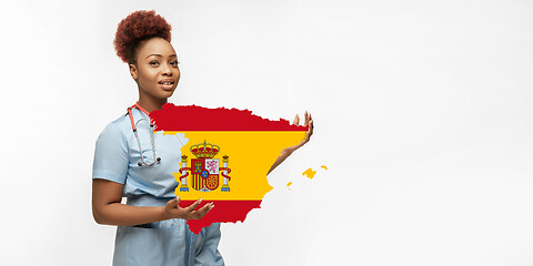 Image showing Beautiful african-american doctor cares about Spain isolated over white studio background