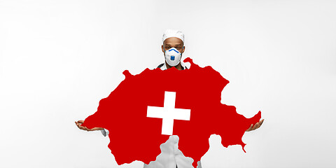 Image showing Beautiful african-american doctor cares about Switzerland isolated over white studio background