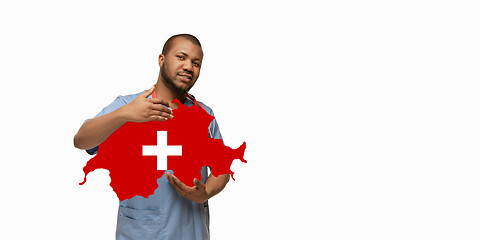 Image showing Beautiful african-american doctor cares about Switzerland isolated over white studio background