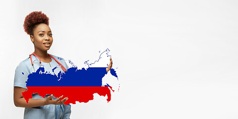 Image showing Beautiful african-american doctor cares about Russia isolated over white studio background