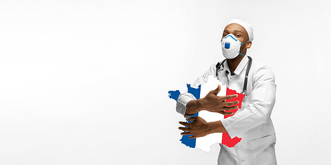 Image showing Beautiful african-american doctor cares about France isolated over white studio background