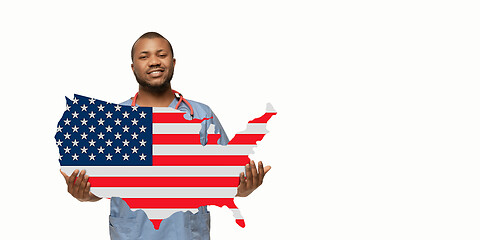 Image showing Beautiful african-american doctor cares about USA isolated over white studio background