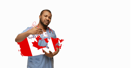 Image showing Beautiful african-american doctor cares about Canada isolated over white studio background