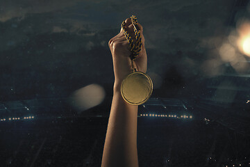 Image showing Award of victory, male hands tightening the medal of winners against cloudy dark sky