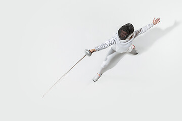 Image showing Teen girl in fencing costume with sword in hand isolated on white background, top view