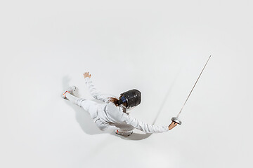 Image showing Teen girl in fencing costume with sword in hand isolated on white background, top view