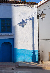 Image showing Lantern and its shadow on blue street