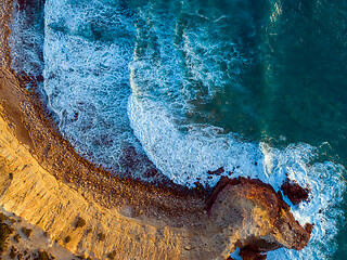 Image showing Aerial top view on rock cliffs and waves