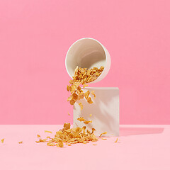 Image showing cornflakes fall out of a white bowl