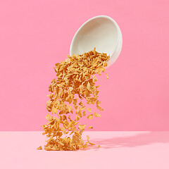 Image showing cornflakes fall out of a white bowl