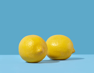 Image showing fresh lemons on blue background