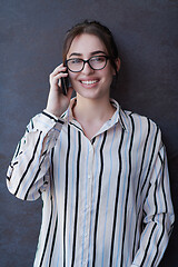 Image showing startup businesswoman in shirt with a glasses using mobile phone