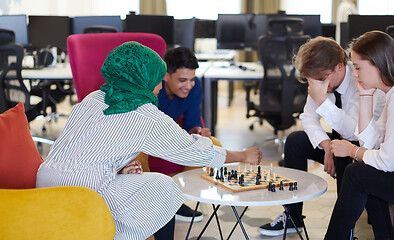 Image showing multiethnic group of business people playing chess