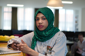 Image showing african muslim business woman using mobile phone