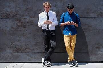 Image showing casual multiethnic startup business men using mobile phone