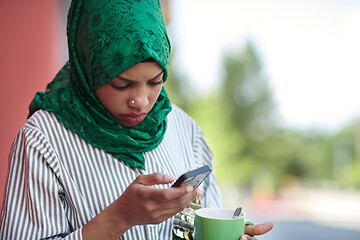 Image showing african muslim businesswoman using mobile phone