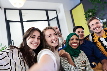 Image showing group of casual multiethnic business people taking selfie