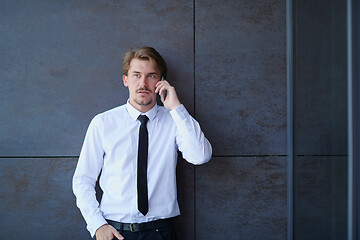 Image showing startup businessman in a white shirt with a tie using mobile pho