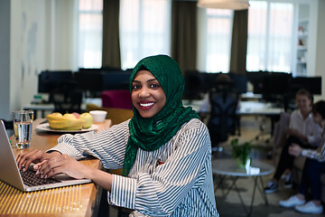 Image showing african muslim business woman working on laptop computer