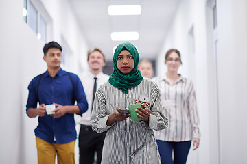 Image showing multi-ethnic startup business team walking through the hallway