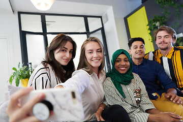 Image showing group of casual multiethnic business people taking selfie