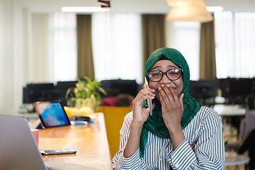 Image showing african muslim business woman using mobile phone