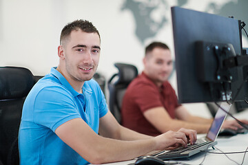 Image showing two male software developers working on computer