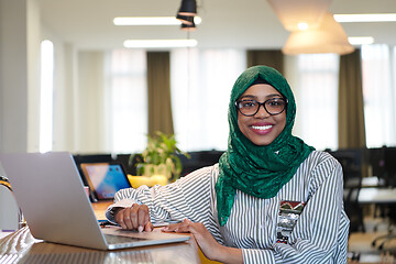 Image showing african muslim business woman working on laptop computer