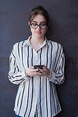 Image showing startup businesswoman in shirt with a glasses using mobile phone