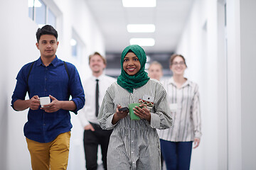 Image showing multi-ethnic startup business team walking through the hallway