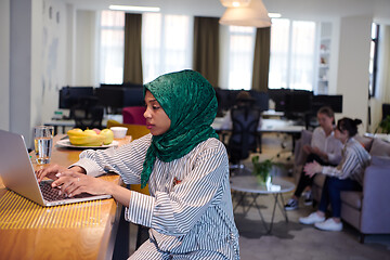 Image showing african muslim business woman working on laptop computer