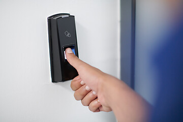 Image showing man pressing fingerprint scanner