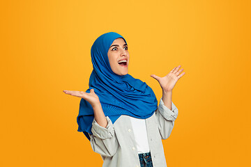 Image showing Portrait of young muslim woman isolated on yellow studio background