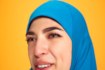 Image showing Portrait of young muslim woman isolated on yellow studio background