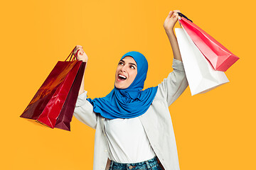 Image showing Portrait of young muslim woman isolated on yellow studio background