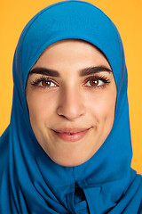 Image showing Portrait of young muslim woman isolated on yellow studio background