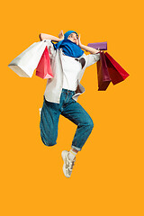 Image showing Portrait of young muslim woman isolated on yellow studio background