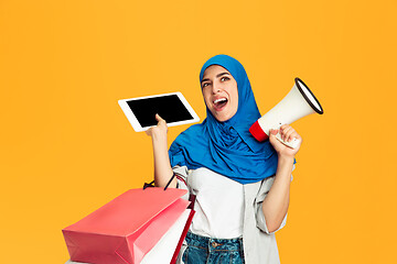 Image showing Portrait of young muslim woman isolated on yellow studio background