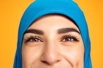 Image showing Portrait of young muslim woman isolated on yellow studio background