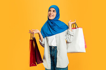 Image showing Portrait of young muslim woman isolated on yellow studio background