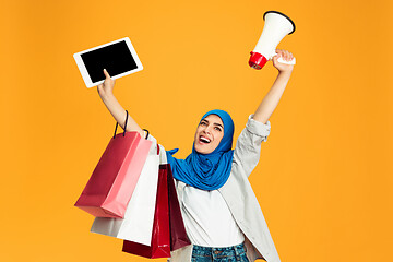 Image showing Portrait of young muslim woman isolated on yellow studio background