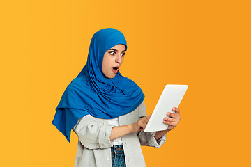 Image showing Portrait of young muslim woman isolated on yellow studio background