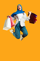 Image showing Portrait of young muslim woman isolated on yellow studio background