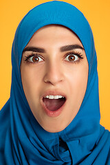 Image showing Portrait of young muslim woman isolated on yellow studio background