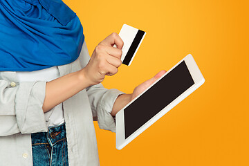 Image showing Close up portrait of young muslim woman isolated on yellow studio background