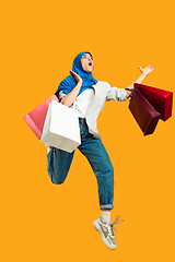 Image showing Portrait of young muslim woman isolated on yellow studio background