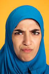 Image showing Portrait of young muslim woman isolated on yellow studio background